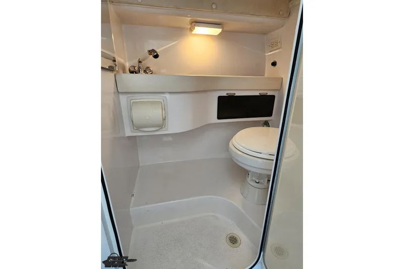 Slide: The Image of 2007 Donzi 35 ZR boat bathroom interior with toilet and sink. - 100