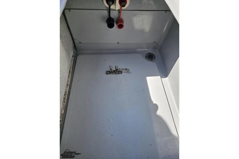 Slide: The Image of 2007 Donzi 35 ZR boat storage compartment with latch and drainage. - 108
