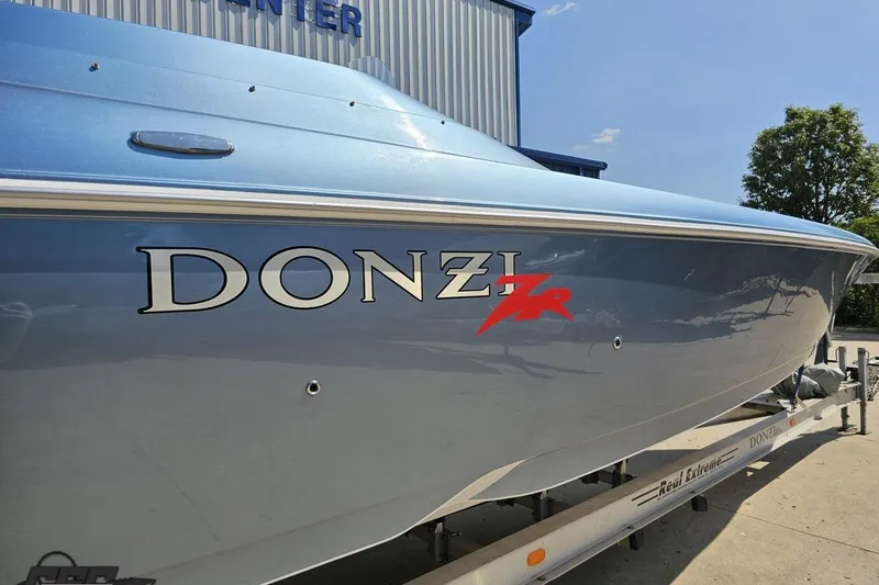 Slide: The Image of 2007 Donzi 35 ZR boat in blue on a trailer, side view. - 11
