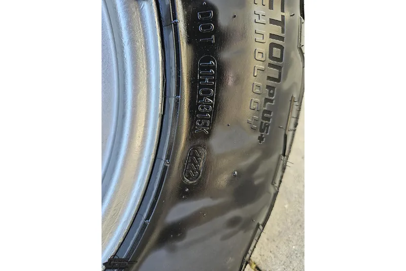 Slide: The Image of Close-up of a tire on a 2007 Donzi 35 ZR, showing tread and DOT code. - 112
