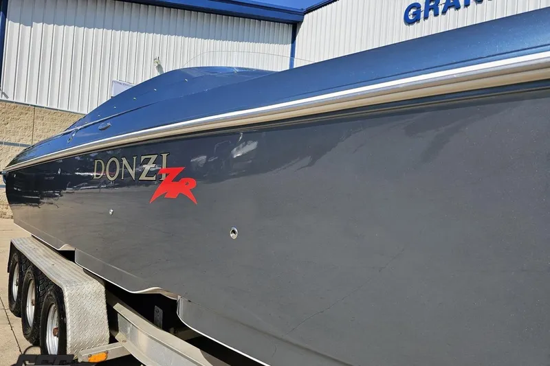 Slide: The Image of 2007 Donzi 35 ZR speedboat on trailer, sleek design, blue exterior. - 13