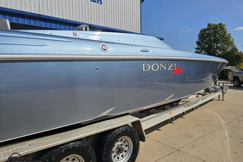 Slide: The Image of 2007 Donzi 35 ZR speedboat on trailer, metallic blue finish, parked outdoors. - 14
