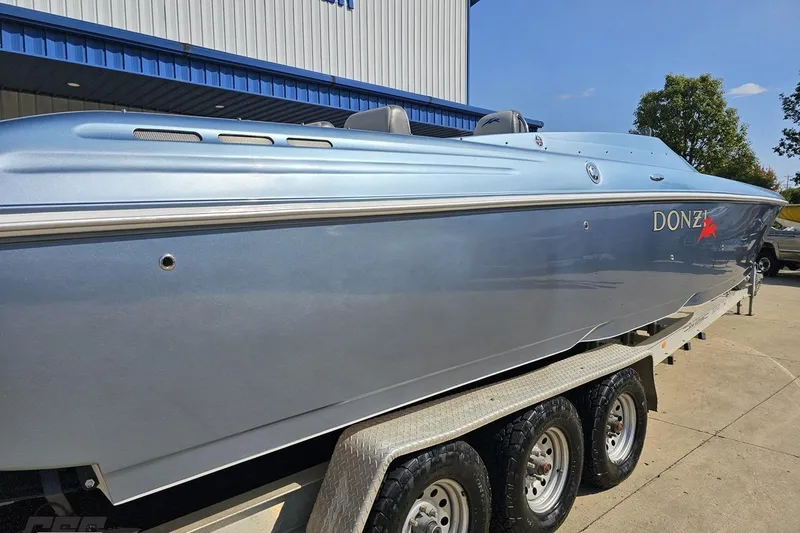 Slide: The Image of 2007 Donzi 35 ZR speedboat on trailer, metallic blue finish, parked outdoors. - 15