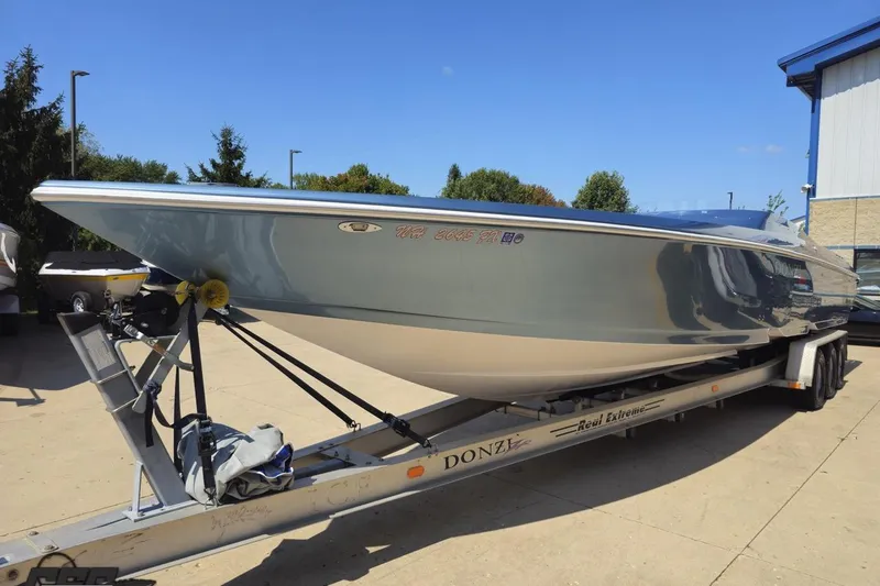 Slide: The Image of 2007 Donzi 35 ZR speedboat on trailer, parked outdoors under clear blue sky. - 21