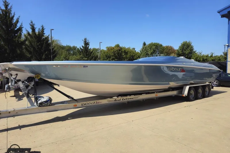 Slide: The Image of 2007 Donzi 35 ZR speedboat on trailer, parked outdoors under clear blue sky. - 22