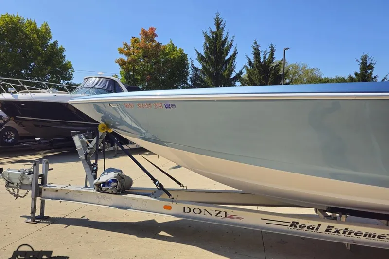 Slide: The Image of 2007 Donzi 35 ZR boat on trailer, parked outdoors under clear blue sky. - 25