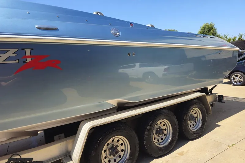 Slide: The Image of 2007 Donzi 35 ZR boat on trailer, sleek blue hull, sunny day. - 28