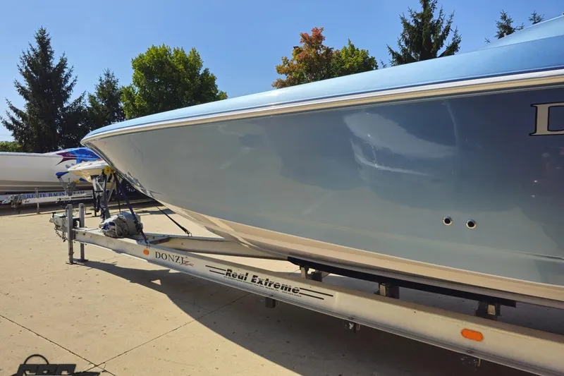 Slide: The Image of 2007 Donzi 35 ZR boat on trailer, sleek design, outdoors with trees in background. - 29