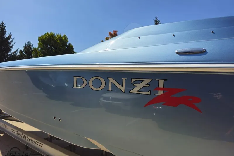 Slide: The Image of 2007 Donzi 35 ZR boat with sleek blue exterior and bold logo. - 31