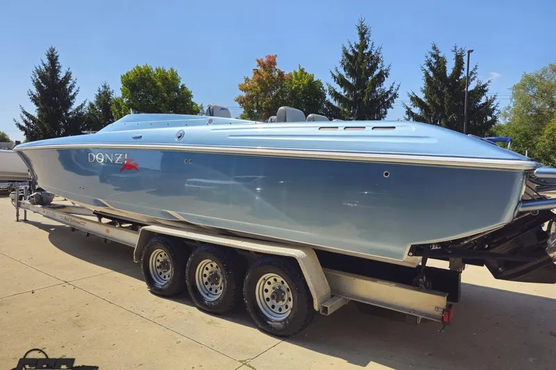 Slide: The Image of 2007 Donzi 35 ZR speedboat on trailer, sleek design, blue finish, sunny day. - 34