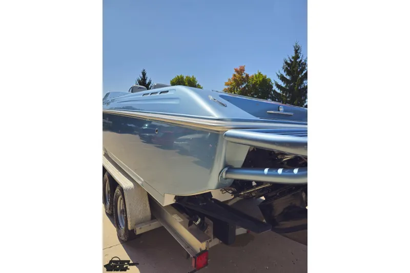 Slide: The Image of 2007 Donzi 35 ZR boat on trailer, sleek design, sunny day, trees in background. - 35