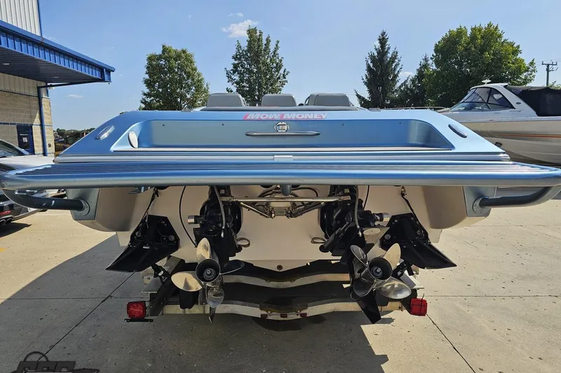 Slide: The Image of 2007 Donzi 35 ZR boat rear view with dual propellers, parked outdoors. - 38