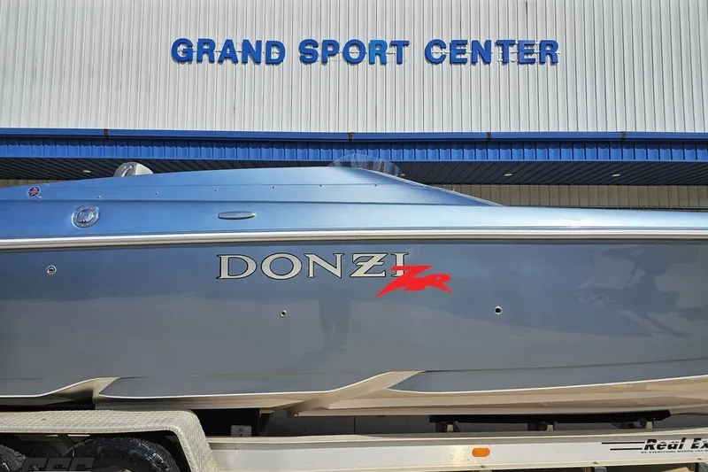 Slide: The Image of 2007 Donzi 35 ZR boat at Grand Sport Center, showcasing sleek design and branding. - 4