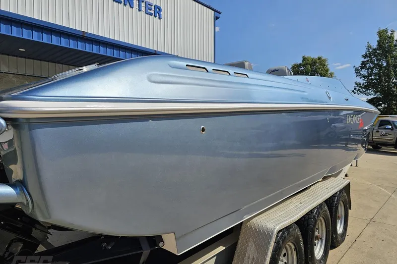 Slide: The Image of 2007 Donzi 35 ZR speedboat on trailer, metallic blue finish, parked outdoors. - 42