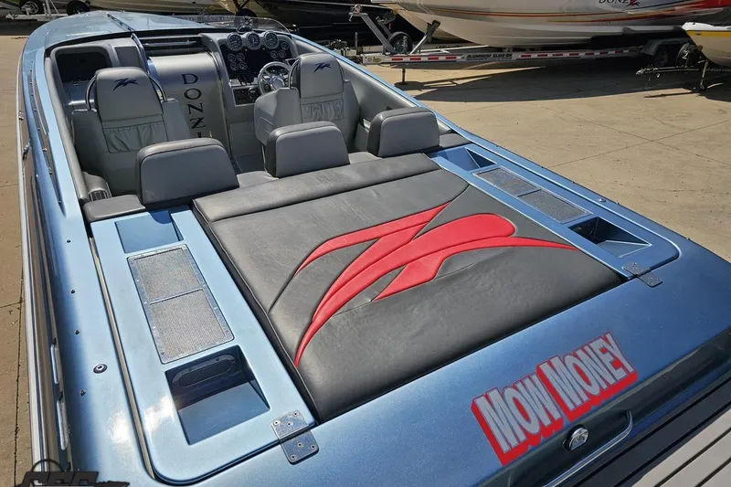 Slide: The Image of 2007 Donzi 35 ZR speedboat with sleek interior and custom "Mow Money" design. - 44