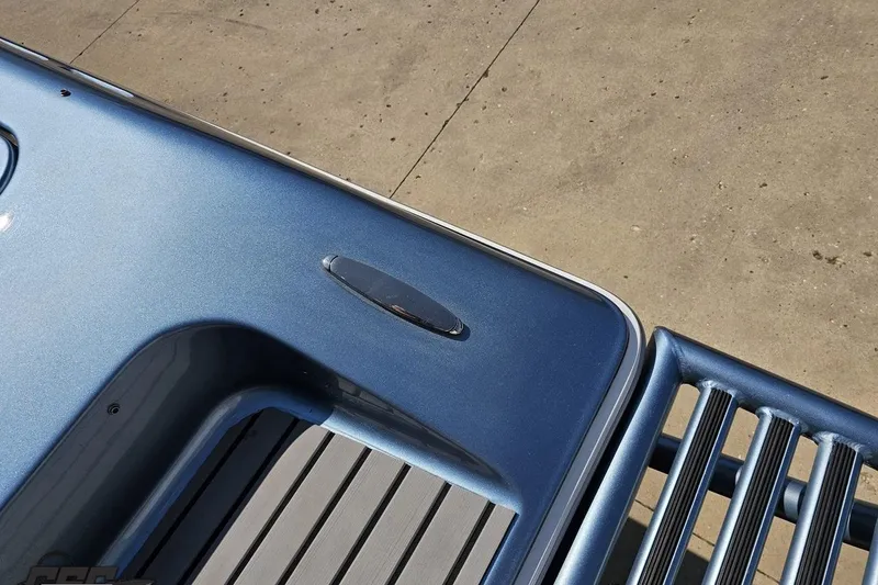 Slide: The Image of 2007 Donzi 35 ZR boat detail, featuring sleek blue metallic finish and deck design. - 48
