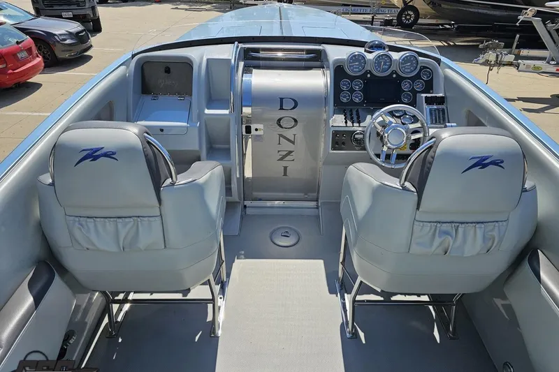 Slide: The Image of 2007 Donzi 35 ZR boat interior with dual seats and dashboard controls. - 56
