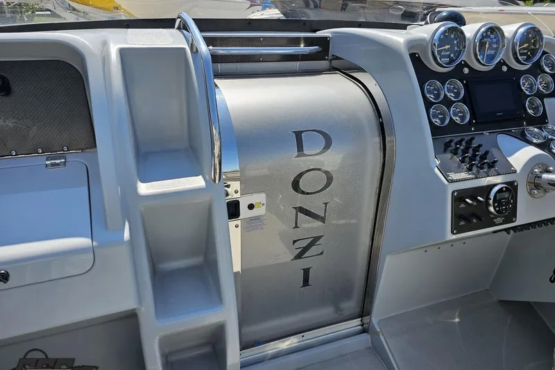 Slide: The Image of 2007 Donzi 35 ZR boat dashboard with gauges and controls. - 64