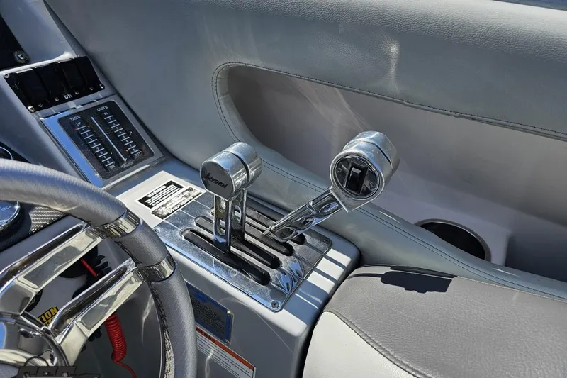 Slide: The Image of 2007 Donzi 35 ZR boat interior with throttle controls and steering wheel. - 67