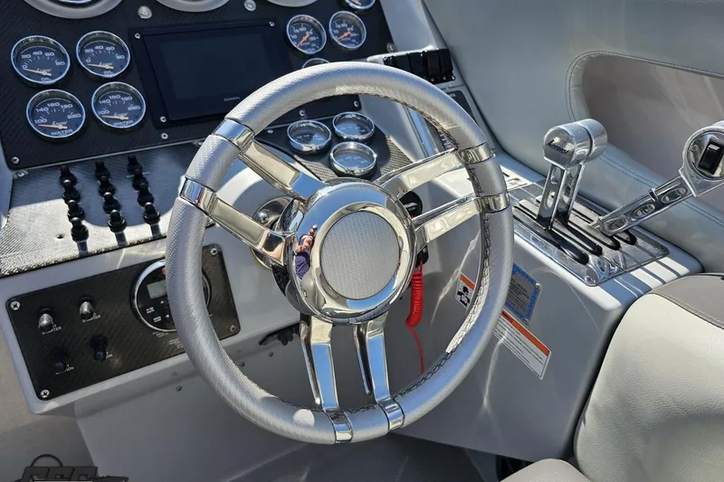 Slide: The Image of 2007 Donzi 35 ZR boat cockpit with steering wheel and control panel. - 68