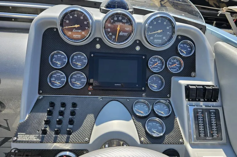 Slide: The Image of Dashboard of a 2007 Donzi 35 ZR boat with gauges and controls. - 69