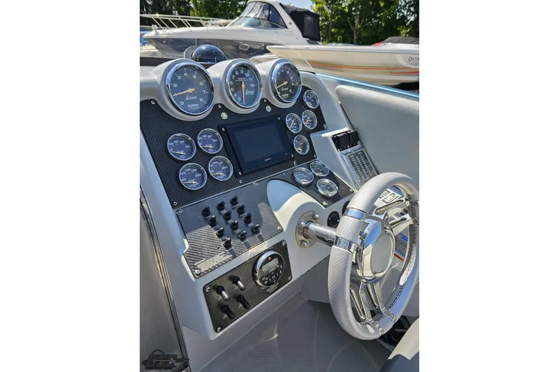 Slide: The Image of Dashboard of a 2007 Donzi 35 ZR boat with gauges and steering wheel. - 70