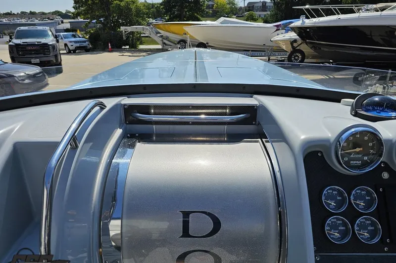 Slide: The Image of 2007 Donzi 35 ZR boat dashboard with gauges and sleek design in a marina setting. - 73