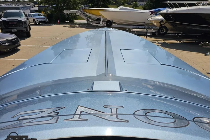 Slide: The Image of 2007 Donzi 35 ZR boat in a parking lot, showcasing sleek design and metallic finish. - 74