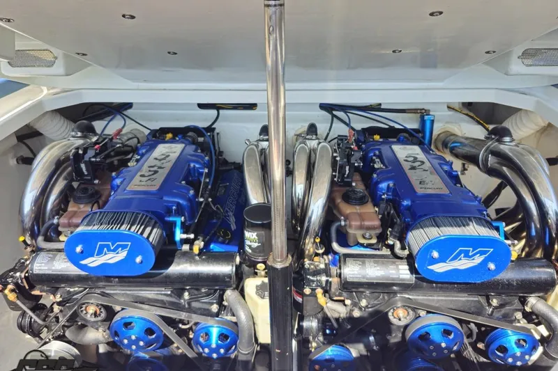 Slide: The Image of 2007 Donzi 35 ZR boat engine compartment with dual blue high-performance engines. - 83
