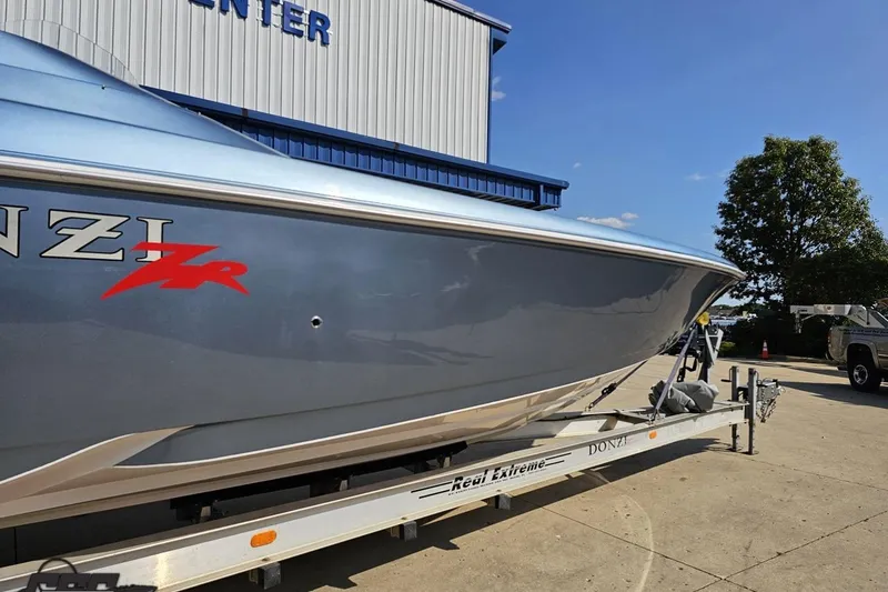 Slide: The Image of 2007 Donzi 35 ZR boat on trailer, parked outside a building under clear skies. - 9