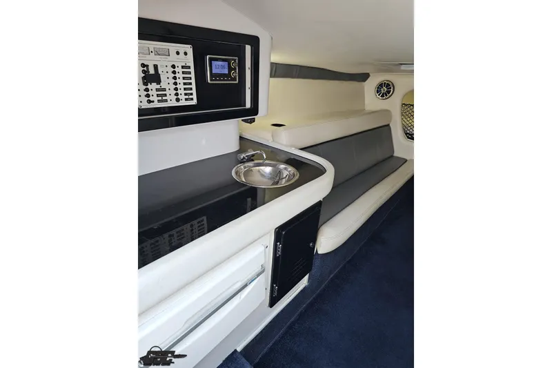 Slide: The Image of Interior of a 2007 Donzi 35 ZR boat, featuring a control panel and seating area. - 90