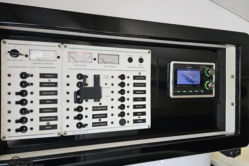 Slide: The Image of Control panel of a 2007 Donzi 35 ZR boat with various switches and gauges. - 92