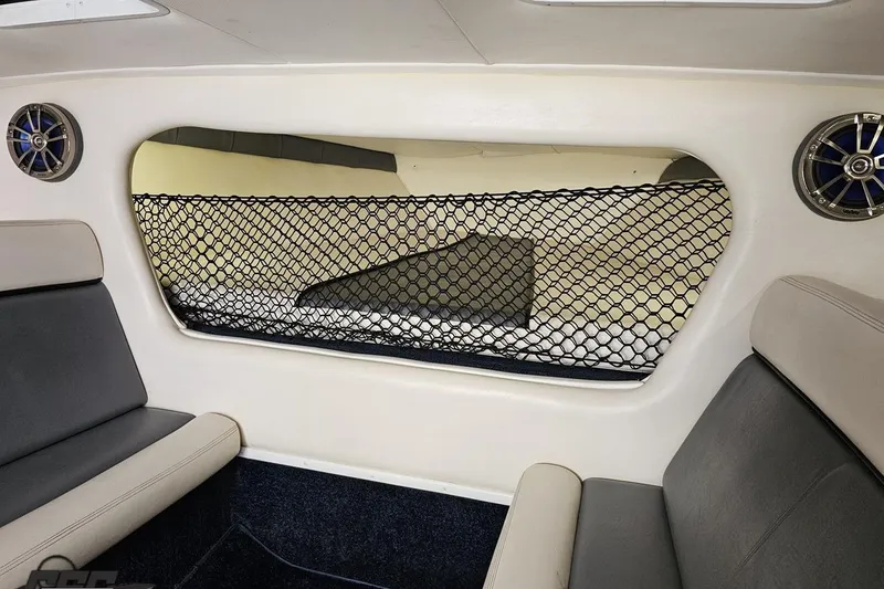 Slide: The Image of Interior of a 2007 Donzi 35 ZR boat with seating and netted storage area. - 96