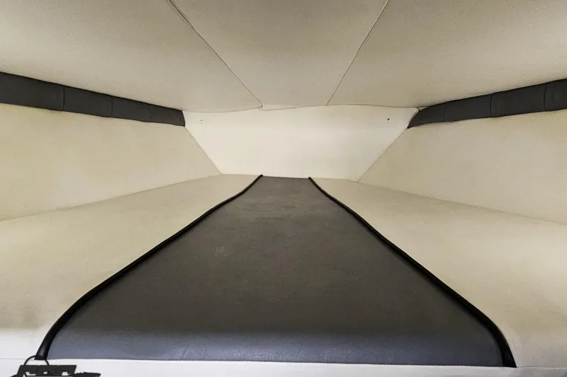 Slide: The Image of Interior cabin of a 2007 Donzi 35 ZR boat, featuring sleek, cushioned seating. - 97