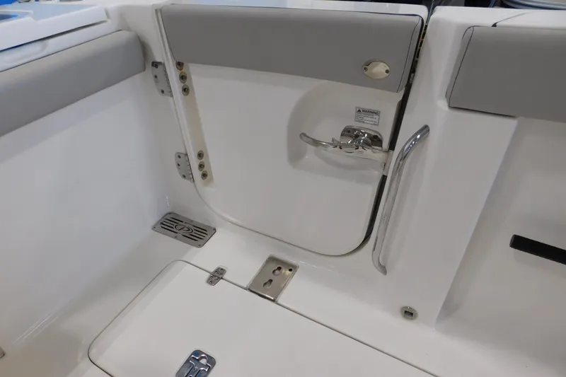 Slide: The Image of 2022 Pursuit S 328 Sport boat interior with sleek white and gray design. - 10