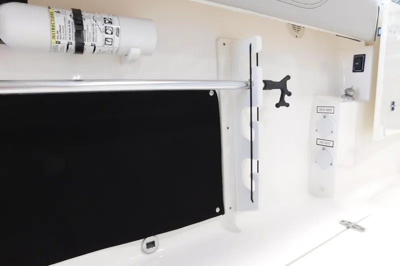 Slide: The Image of 2022 Pursuit S 328 Sport boat interior with fire extinguisher and water controls. - 11