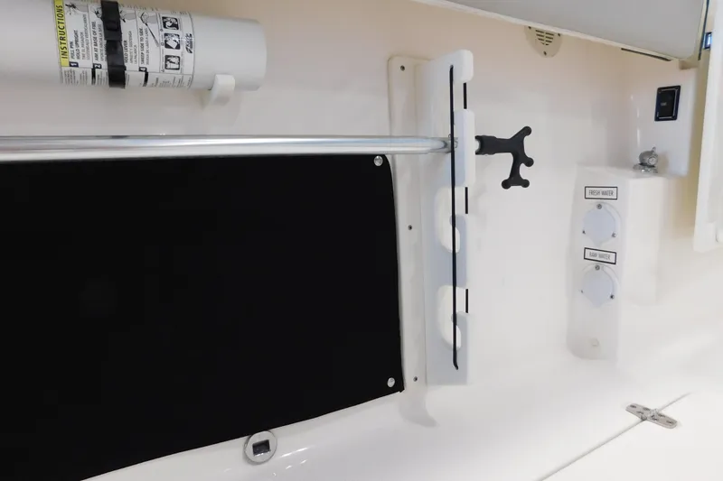 Slide: The Image of 2022 Pursuit S 328 Sport boat interior with safety equipment and water controls. - 13