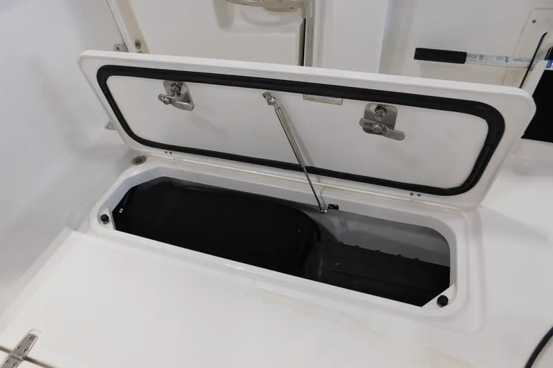 Slide: The Image of Open storage compartment on 2022 Pursuit S 328 Sport boat. - 16