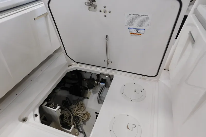 Slide: The Image of 2022 Pursuit S 328 Sport boat storage compartment with ropes and equipment. - 18