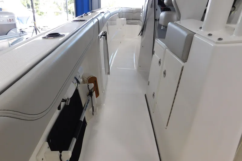 Slide: The Image of 2022 Pursuit S 328 Sport boat interior with sleek white design and storage compartments. - 21