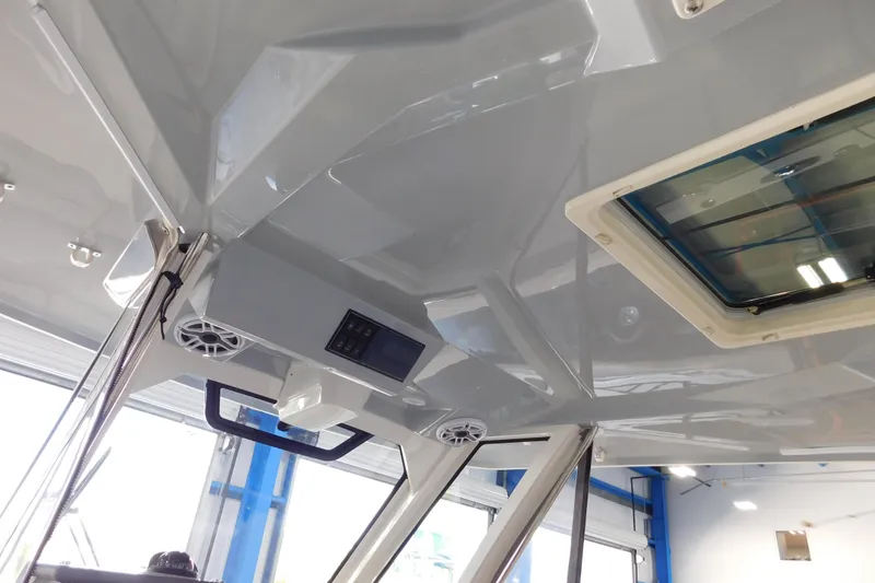 Slide: The Image of 2022 Pursuit S 328 Sport boat interior with speakers and hatch. - 26