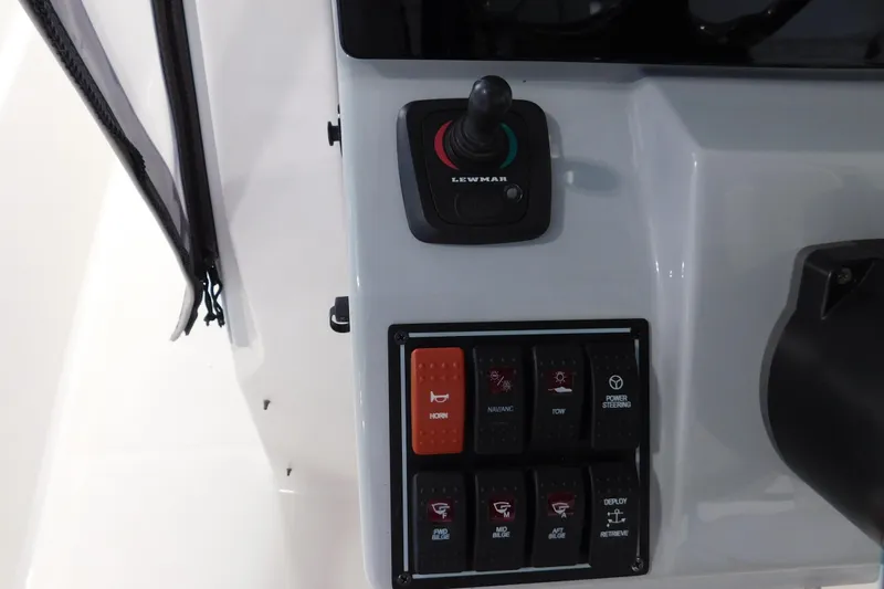 Slide: The Image of Control panel of 2022 Pursuit S 328 Sport boat with joystick and switches. - 28