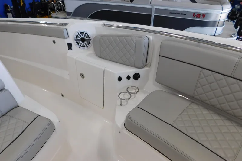 Slide: The Image of 2022 Pursuit S 328 Sport boat interior with cushioned seating and cup holders. - 39
