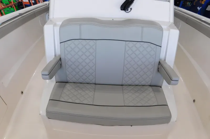 Slide: The Image of 2022 Pursuit S 328 Sport boat seat with quilted gray upholstery and armrests. - 41