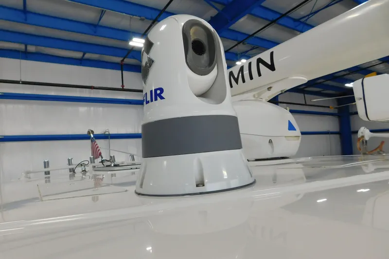 Slide: The Image of 2022 Pursuit S 328 Sport boat with FLIR and Garmin equipment in a blue-roofed facility. - 43