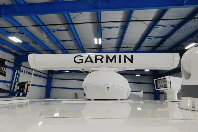 Slide: The Image of Garmin radar on 2022 Pursuit S 328 Sport boat in a blue-roofed warehouse. - 44