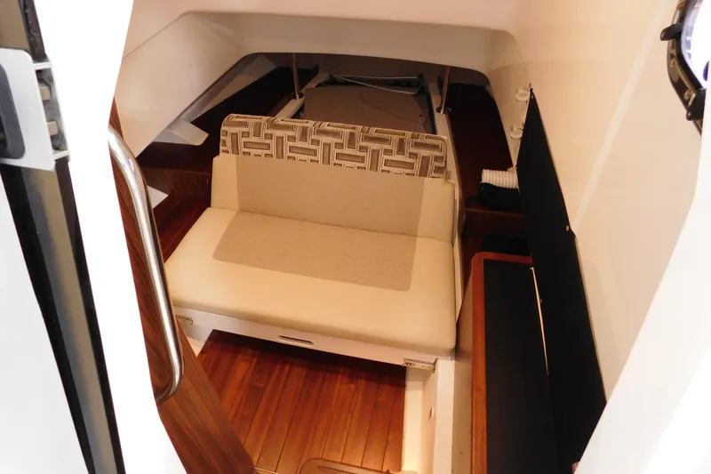 Slide: The Image of 2022 Pursuit S 328 Sport cabin interior with seating and wooden flooring. - 48