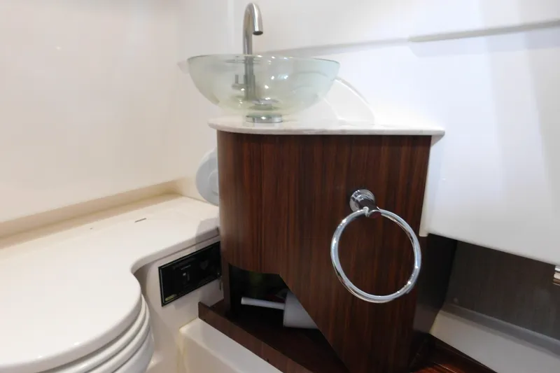 Slide: The Image of 2022 Pursuit S 328 Sport boat bathroom with modern sink and wooden cabinet. - 50