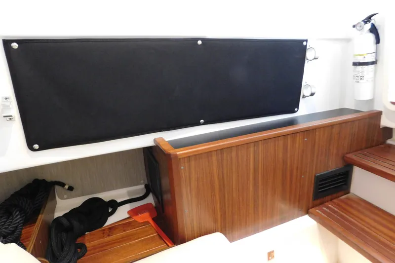 Slide: The Image of 2022 Pursuit S 328 Sport interior with wooden accents and safety equipment. - 52