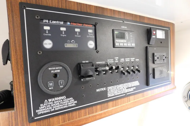 Slide: The Image of Control panel of 2022 Pursuit S 328 Sport boat with various switches and warnings. - 55
